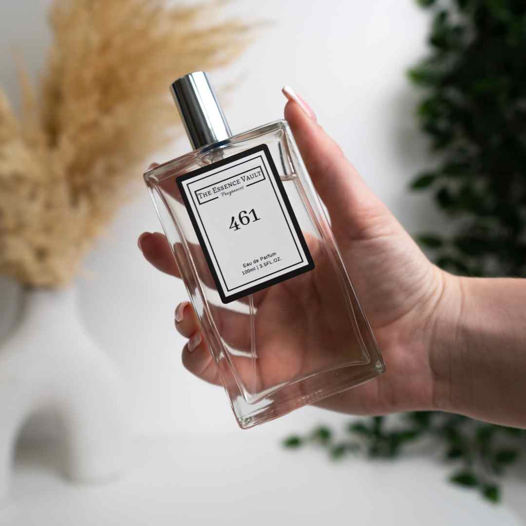 Image of a perfume from The Essence Vault being held up in front of some plants, for the blog Discover Your Scent: How to Choose Perfume