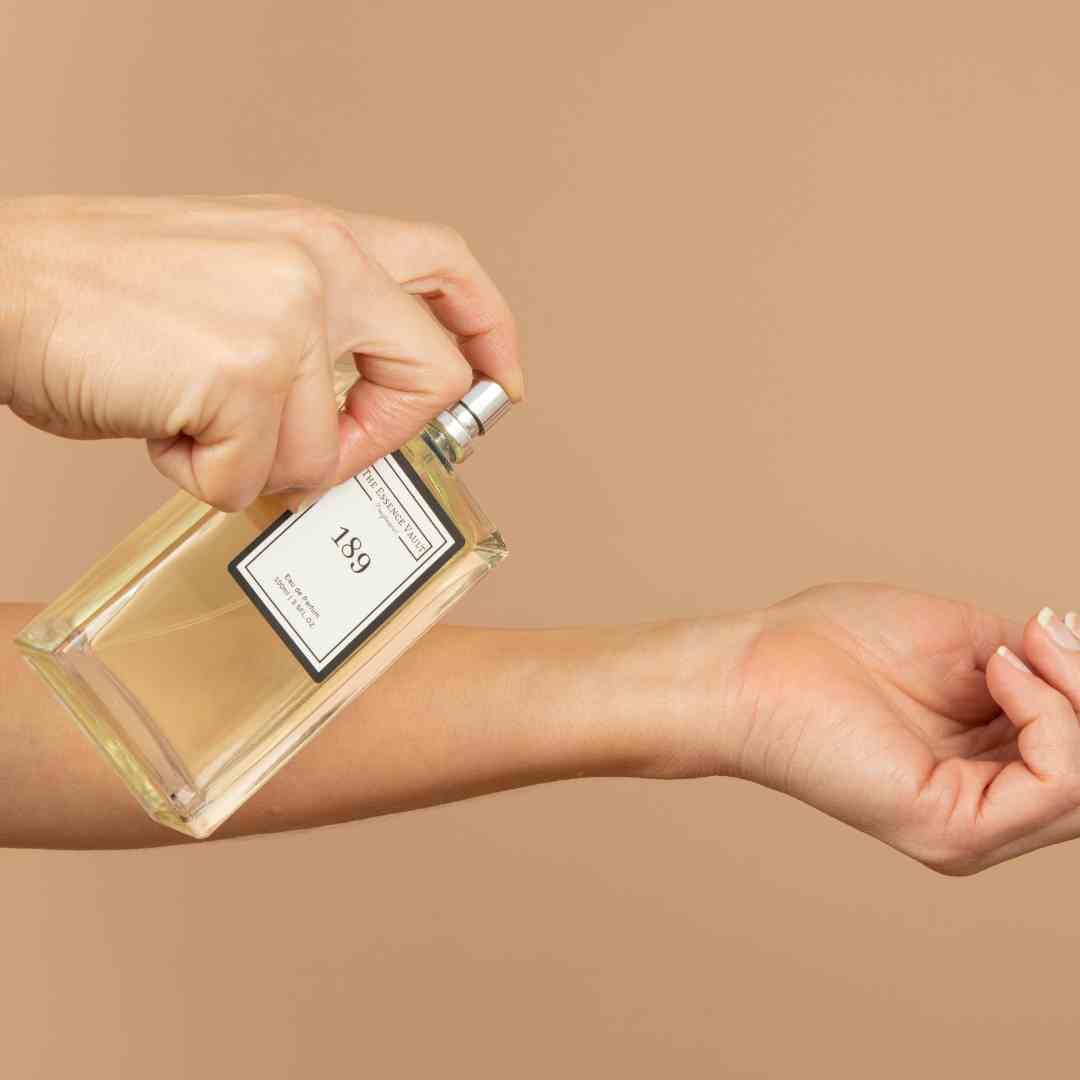 Image of an Essence Vault perfume being sprayed onto a woman's wrist, Why Do Women Put Perfume On Their Wrists and Ankles